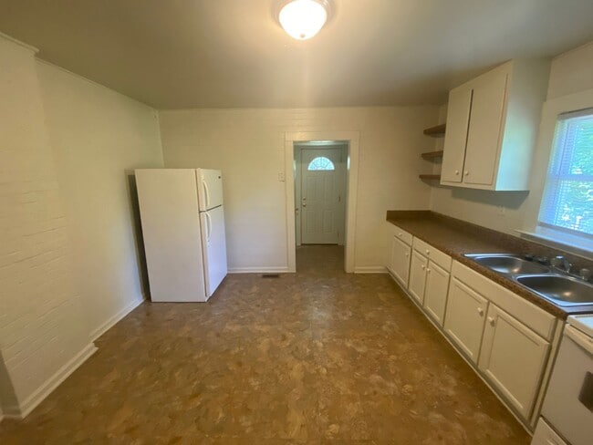 Building Photo - Big kitchen. Fenced yard. Walltown location. Under $1,300.