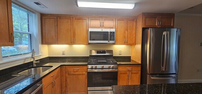 Building Photo - Spacious 2-bedroom townhouse on beautifully landscaped grounds.