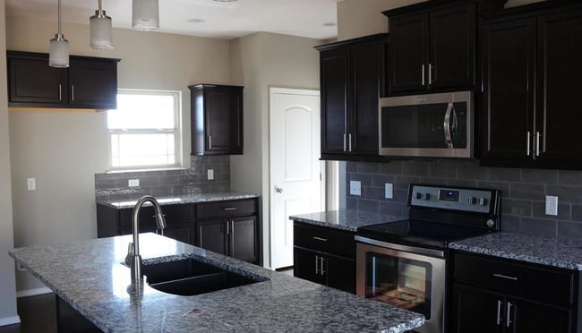 Building Photo - Fenced in 4 bedroom home with Second Living Space