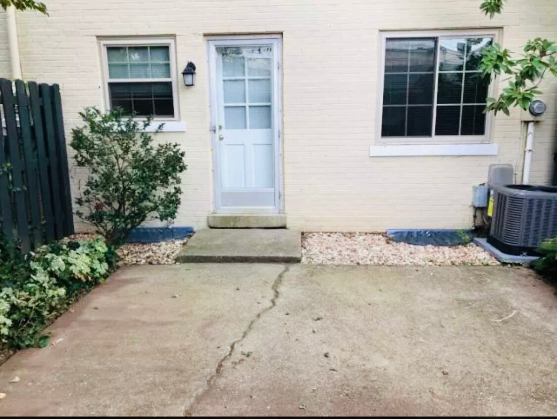 Outdoor patio and garden space with walkway to covered parking space - 1149 Cooper Dr