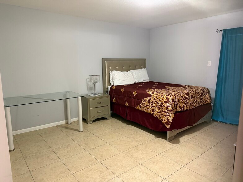 Bright second bedroom ideal for guests, roommates, or a home office. - 8427 Hearth Dr
