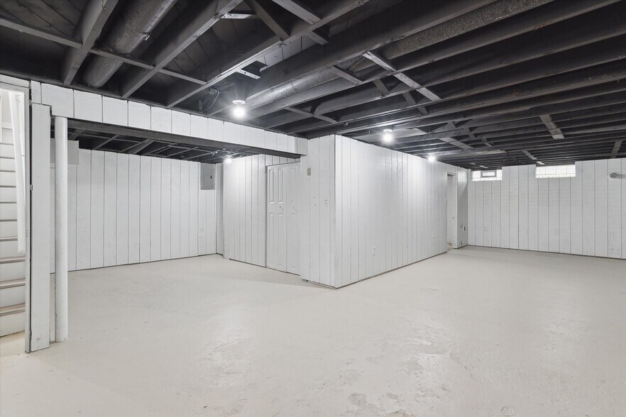 Basement rec room with overhead lighting and electrical outlets throughout. - 9244 Northern Ave