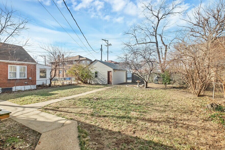 Oversized backyard is fully fenced and very private when plants are in bloom. The back patio is spacious with electrical service allowing for party lights in the trees. Trees totally shade the patio during the summer. - 3443 Lawn Ave