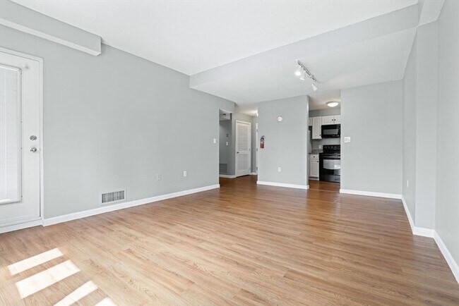 Building Photo - Updated 1BR Condo with Balcony, Garage Parking & Storage Near Commuter Rail