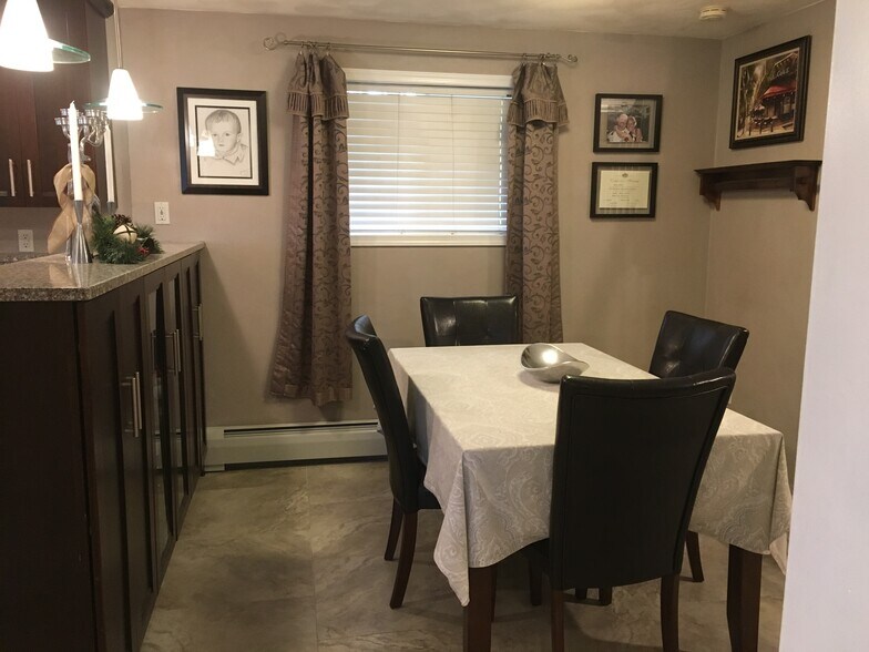 Dining area with built in cherry display cabinet. 24x24 Porcelain tiles and In floor radiant heating through out. - 924 Byford Boulevard
