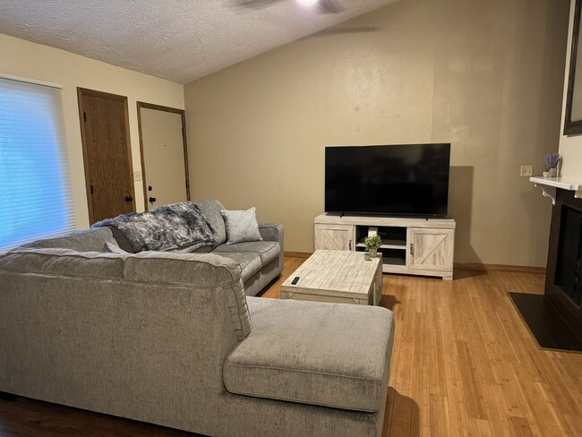 large living room with 65 inch Television - 4449 Charles St