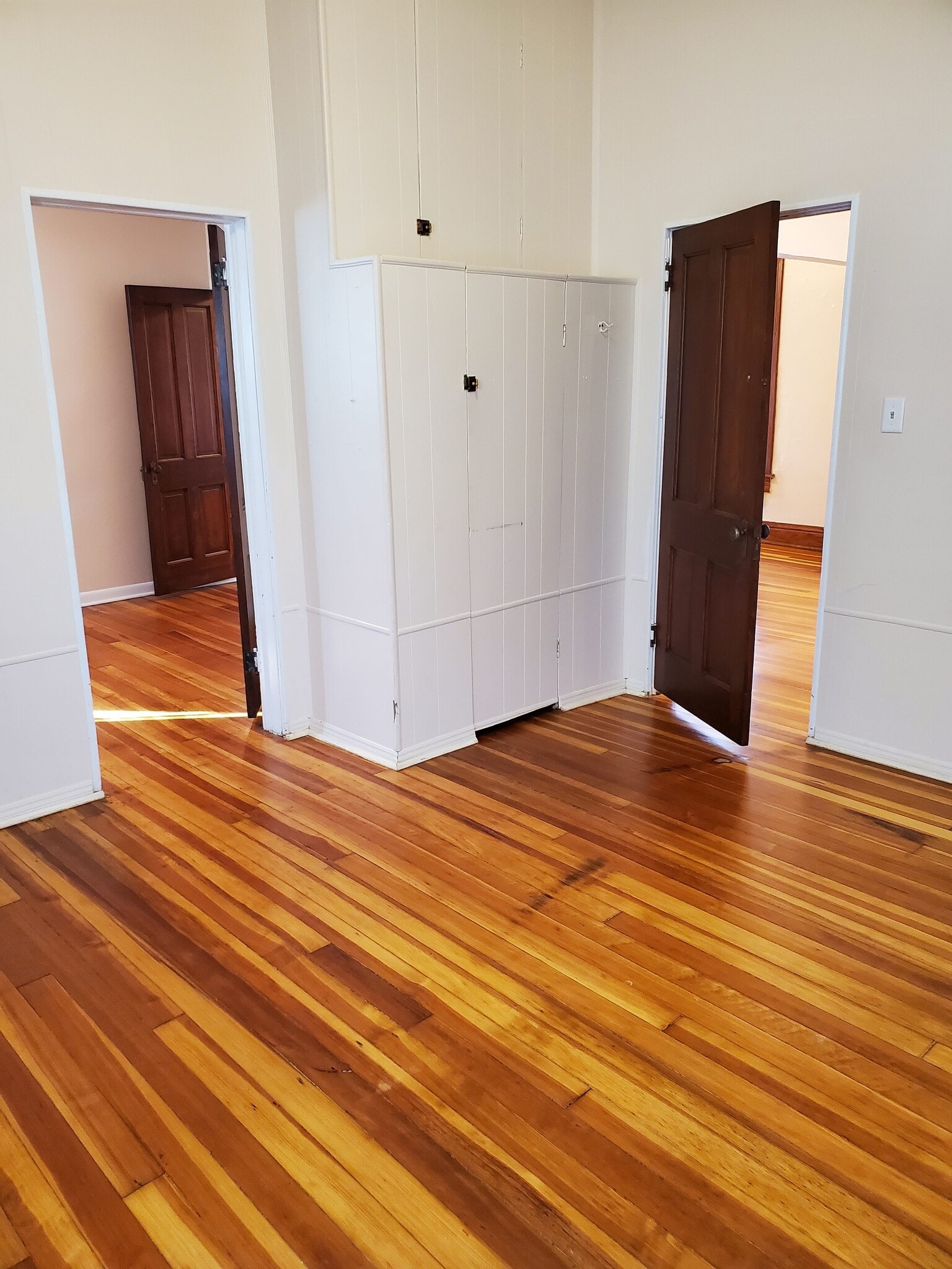 Back bedroom adjoins middle bedroom with door between the two. Door leads to living spaces. - 607 Harrison Ave