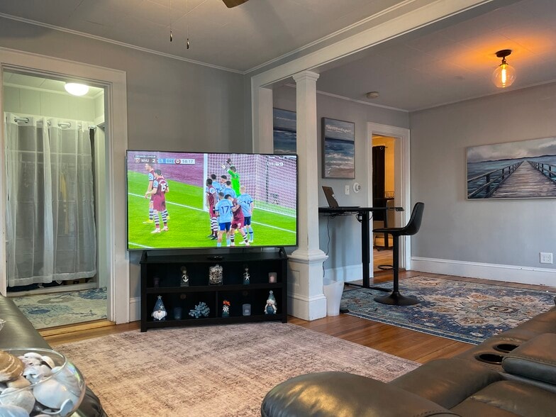 Living Room with laundry room on left. Dining room/Office space - 20 Crescent St