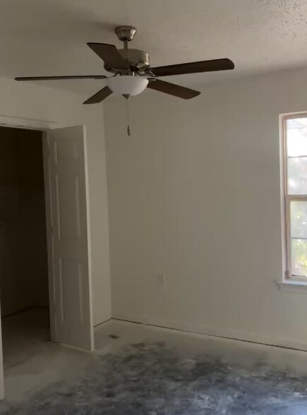 Spacious primary bedroom with roomy closet and modern ceiling fan. - 4720 Burma Rd