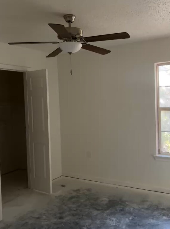 Spacious primary bedroom with roomy closet and modern ceiling fan. - 4720 Burma Rd