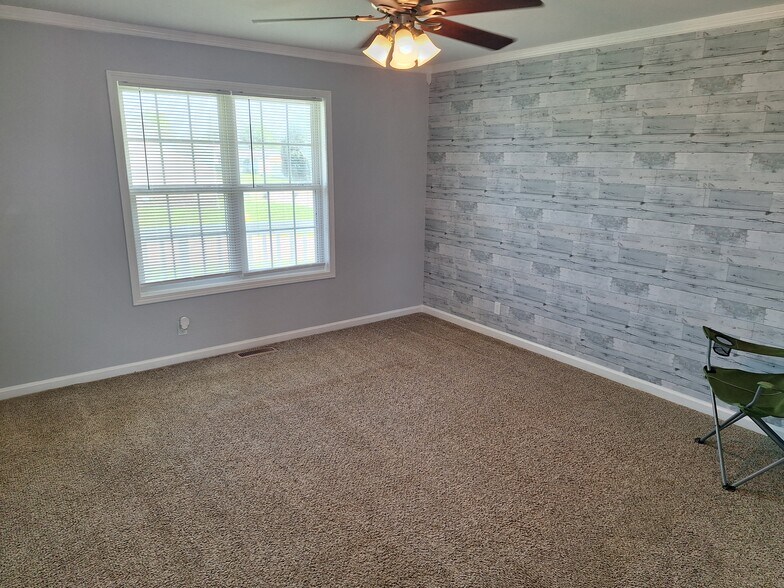 Living room with accent wall, ceiling fan - 695 Artic Ave