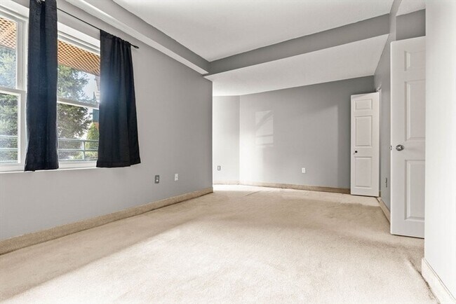 Building Photo - Updated 1BR Condo with Balcony, Garage Parking & Storage Near Commuter Rail