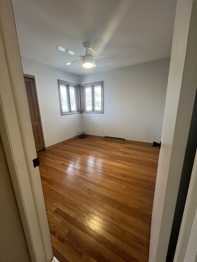 Bedroom 2 with ceiling fan and hardwood floor - 3007 S 95th St