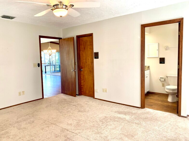 Main bedroom with adjoining bathroom. Main bedroom also has two walk in closets. - 5203 15th St W