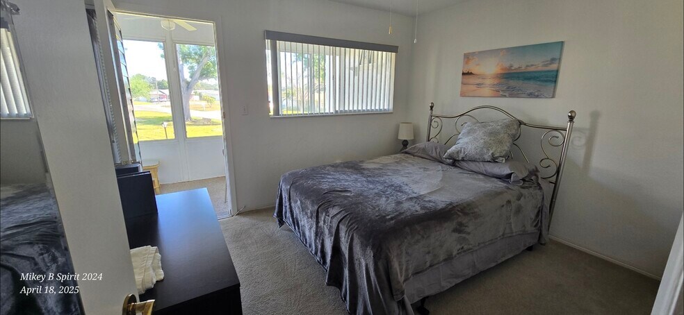 Queen bed in 2nd Bathroom leading to outside patio - 8525 111th St
