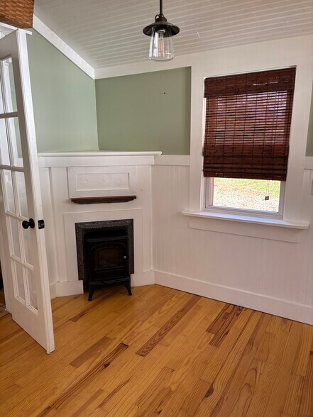 Electric stove fireplace in sunroom - 127 Shelburne Rd