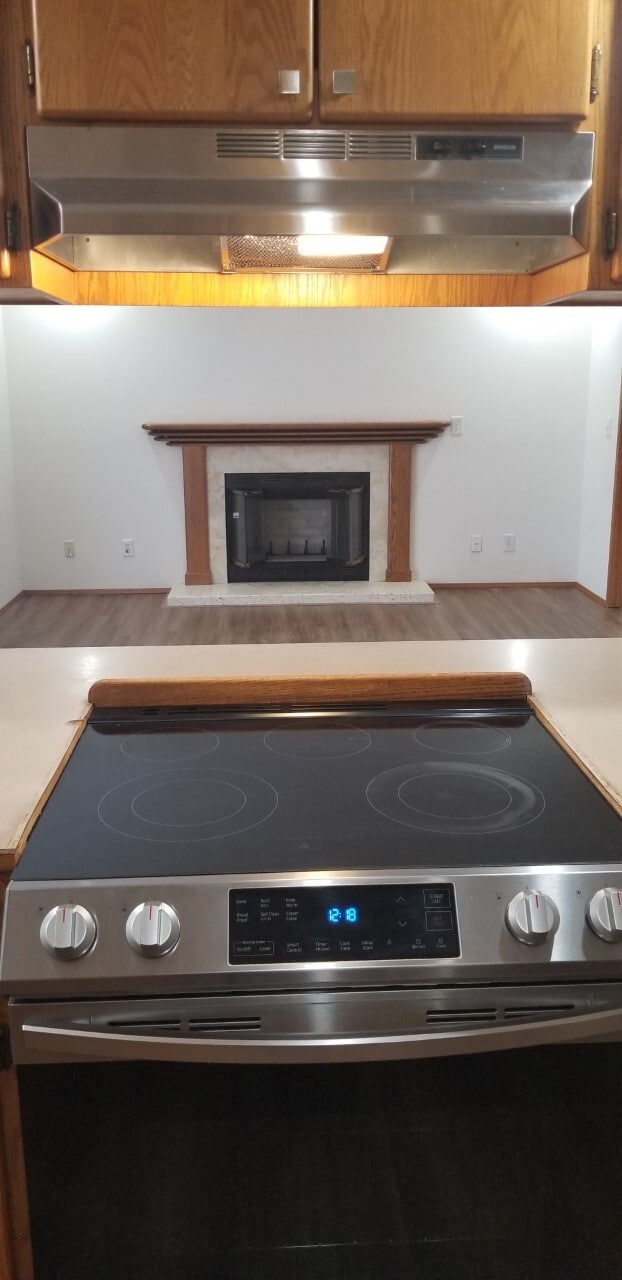 View of fireplace whie cooking - 10615 Hillsboro Dr NW