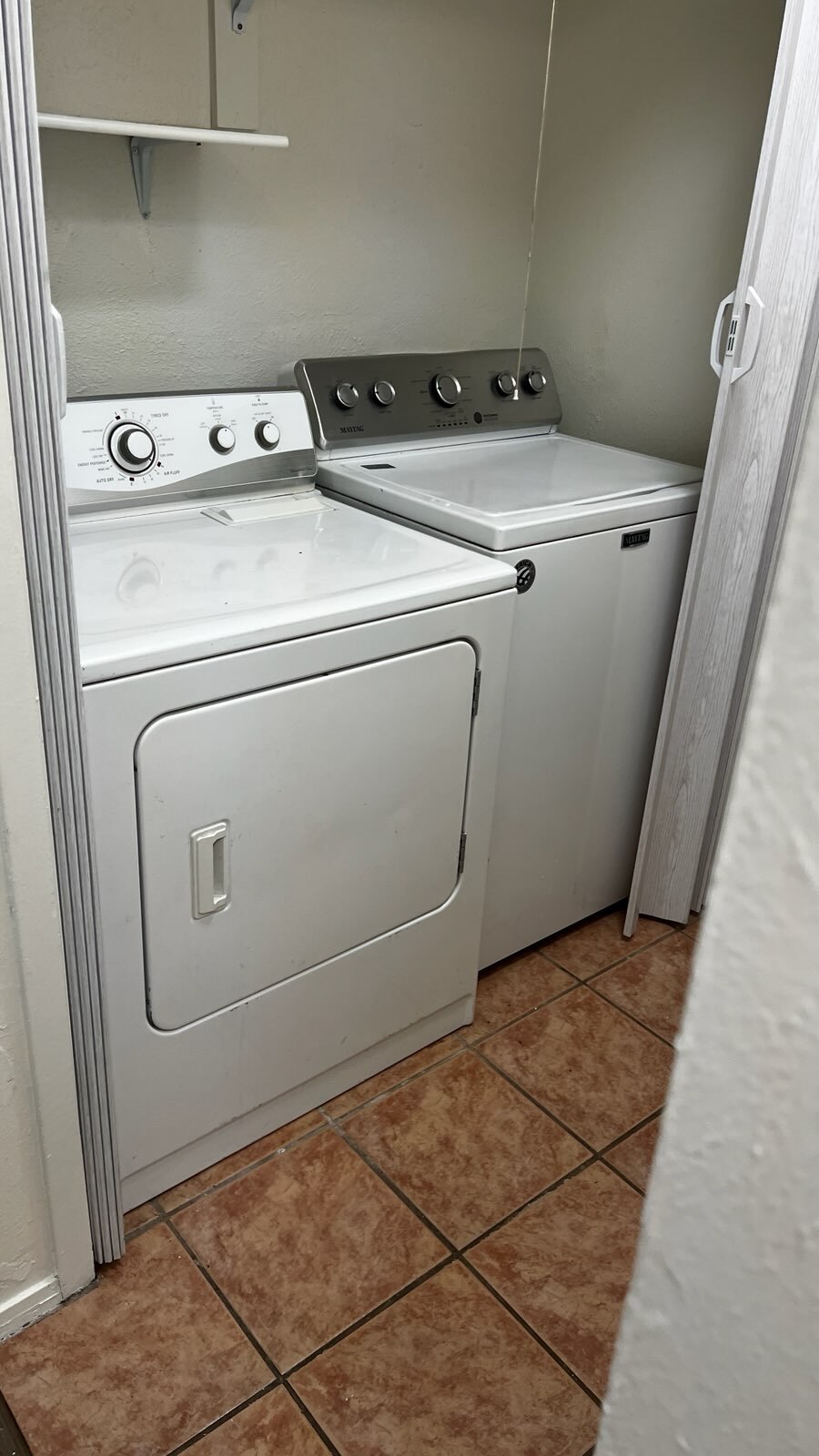 Laundry area with light tile patterned floors and washing machine and dryer - 5906 Wagon Bnd