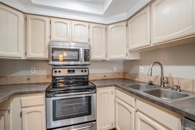 Kitchen with stainless steel appliances. Fridge is not pictured on left hand side - 701 Harlan St