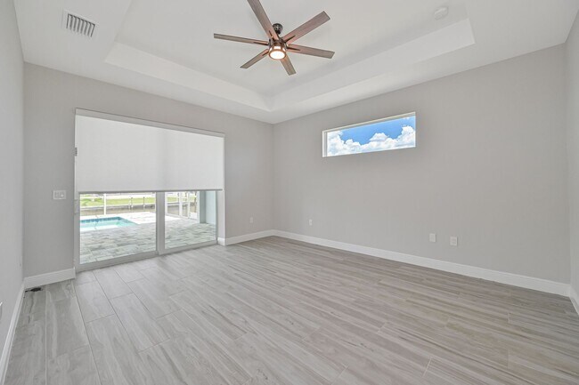 Building Photo - NOW AVAILABLE - Gorgeous Pool Home ~ NW Cape ~ 3 Car Garage ~ On Canal!