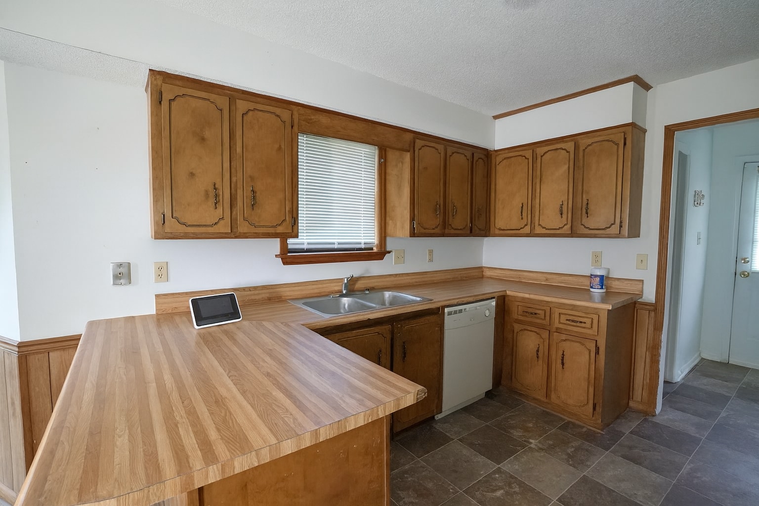 Spacious kitchen with ample storage, breakfast bar, and double sink for easy entertaining. - 2313 Salem West Dr