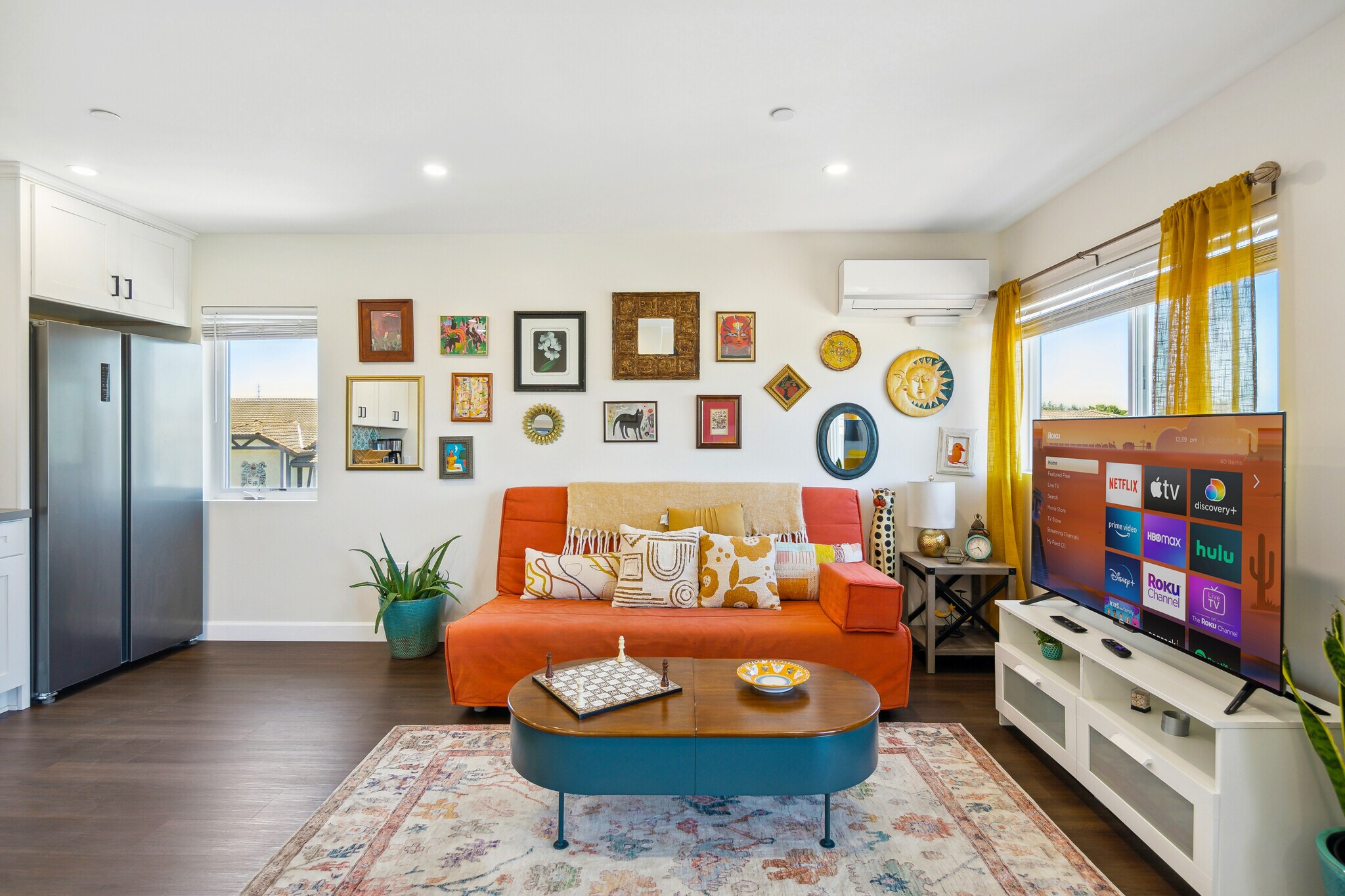 Sink into the vibrant, sunny living room and put your feet up after a long day. - 721 E 22nd St