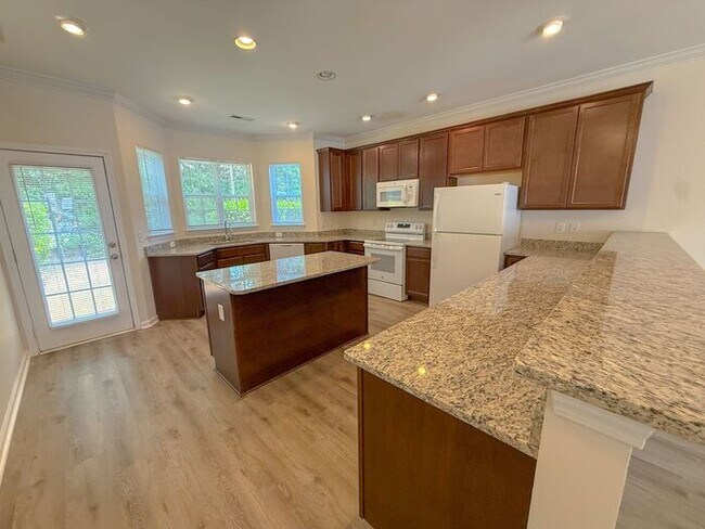 Building Photo - Beautifully updated Townhome! New cabinets, granite counter tops, and LVP flooring through downst...
