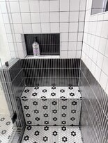 Huge walk in shower with a built in bench and window for natural light - 570 Saint Charles Ave NE