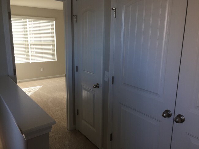 Hallway area landing with laundry and linen closet - 1816 Riverbirch Lane