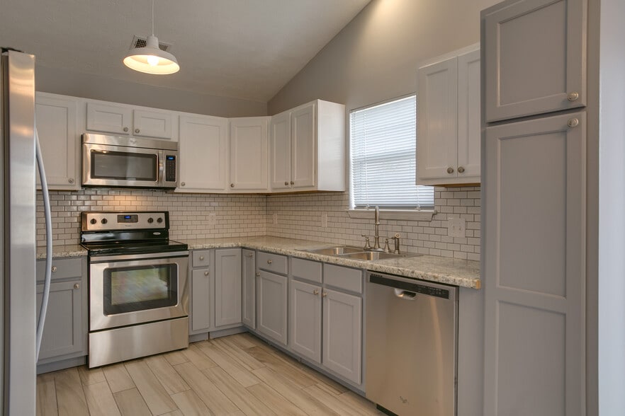 Renovated kitchen with stainless steel appliances - 1139 Alandee St.