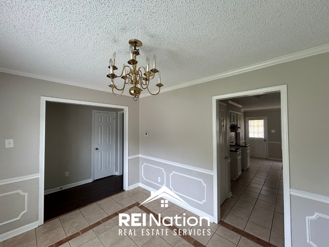 Building Photo - Spacious 4BR/2BA Near Southwind | High Ceilings, Brick Fireplace & 2-Car Garage