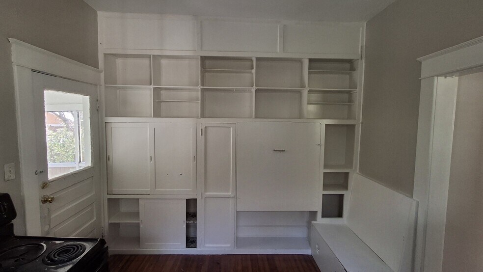 kitchen has built in cabinetry and a fold down table - 607 Guilford Ave