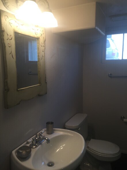bathroom sink and mirror - 4155 N Raleigh St