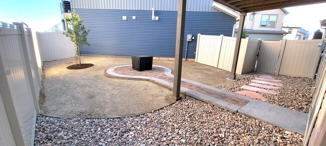 Low maintenance back yard with area for firepit and seating - 6153 Ashmore Ln