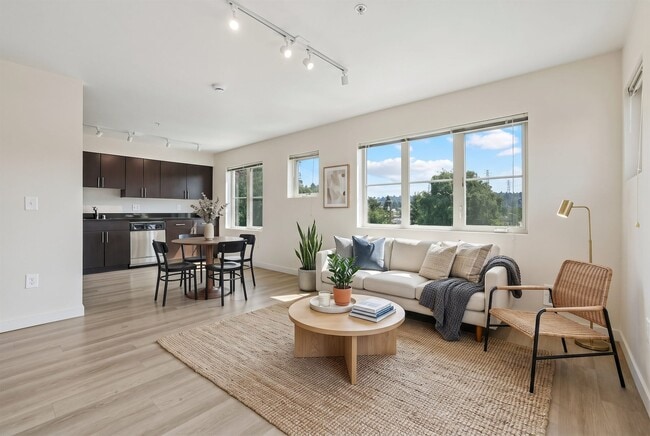 Bright open layout connecting the living room and dining space to the kitchen at REV Fremont in Seattle. - REV Fremont
