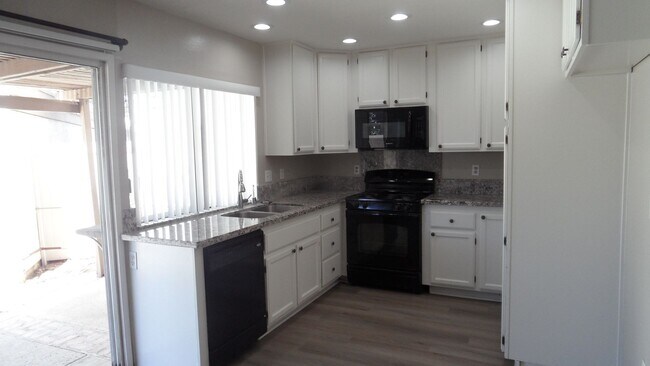 Building Photo - Two Story 4 BR 2.5 BA Condo With 2 Car Garage