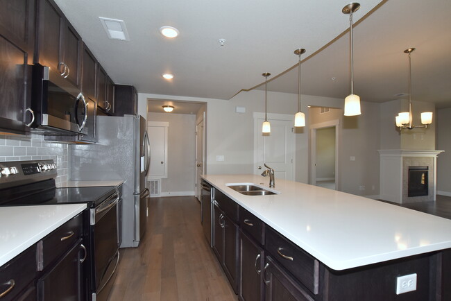 Grey maple cabinets and quartz counters - 6510 Crystal Downs Dr