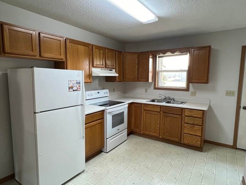 Kitchen with back patio door. - 409 E Soo St