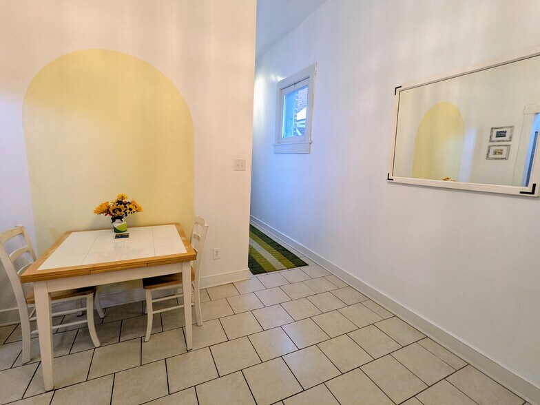 Living/kitchen on left, hall to bedrooms on right. - 1816 W Grace St