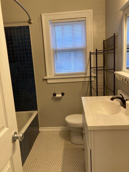 Bathroom, with original tile floors, large deep bathtub - 1503 N Broadway Ave