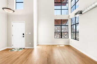 Building Photo - Modern 2BD, 1.5BA Condo with 20' Ceilings and Garage Parking Spot
