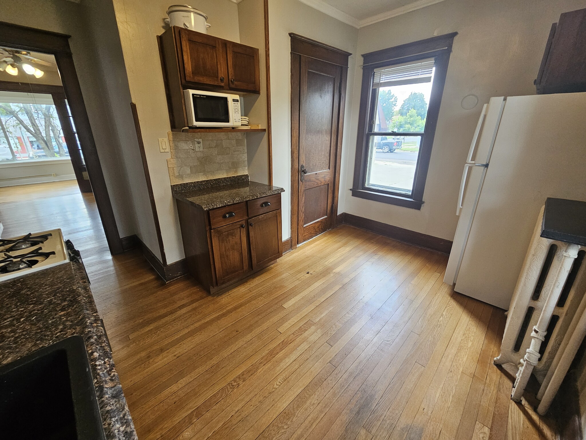 Kitchen w/ full size fridge - 1335 W Minnehaha Ave