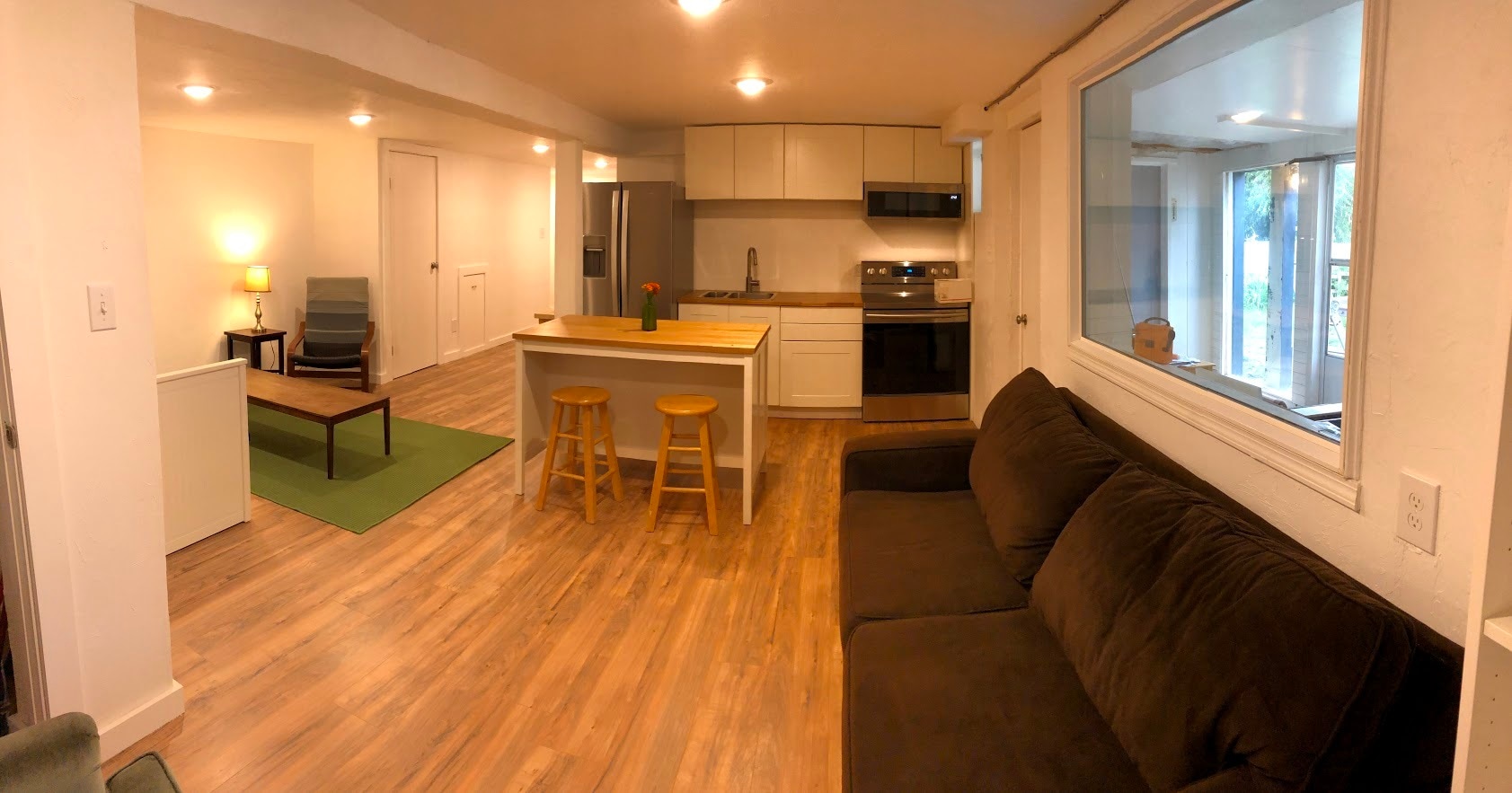 Kitchen and living area. Entrance to apartment on right side of photo, from the large mud room. Click on photo for wider view. Furnishings not included. - 2415 E 12th St