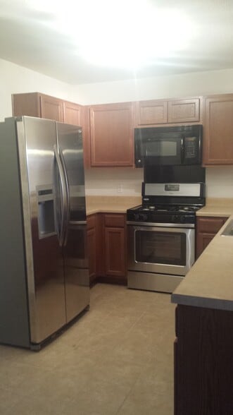 Stainless steel appliances in an open kitchen - 5713 Abby Ann Ln
