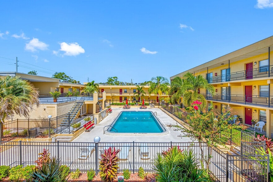 Vibrant apartment community featuring a luxurious outdoor pool, surrounded by lush tropical landscaping and modern amenities. - Parkview Apartments