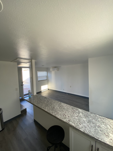 A view from the kitchen by the fridge, over the bar top. - 1911 W 94th St