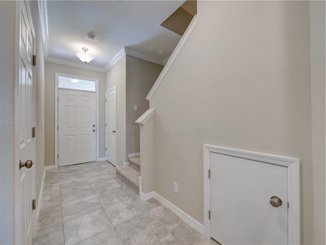 Main Entrance, with way going upstairs, also an entry from the garage door. High Ceiling Height - Ex - 1074 Amber Leaf Trail