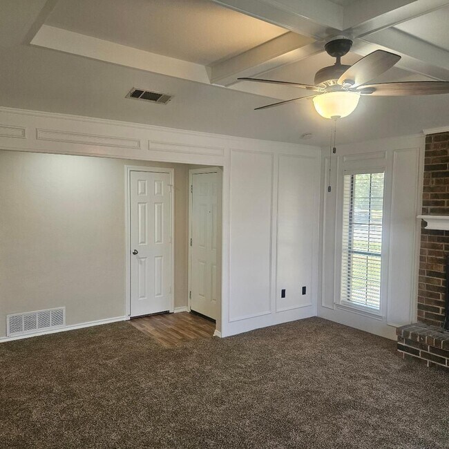 Building Photo - Three bedroom and two bathroom nicely remodeled with new flooring. Large wood fenced backyard