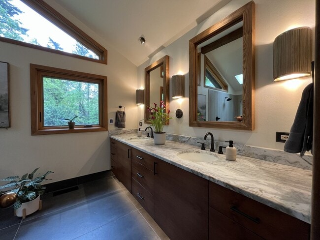 Building Photo - One-of-a-Kind Custom Home with Wall of Windows, Stone Fireplaces, Expansive Entertainment Space &...