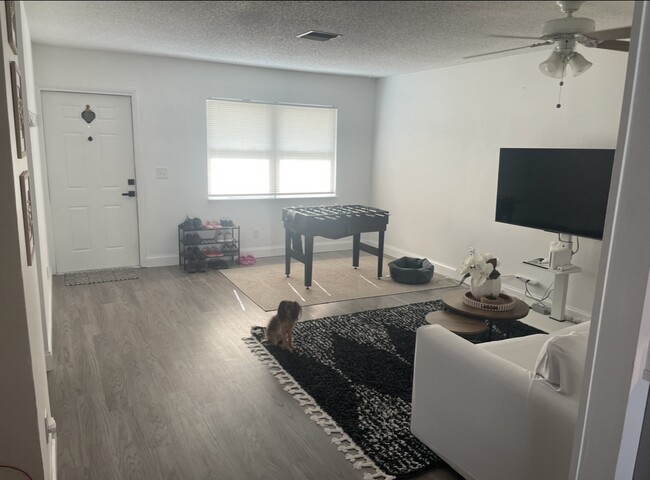 Living room, see the new floors and new hurricane impact window examples throughout the whole house. - 767 SW Ravenswood Ln